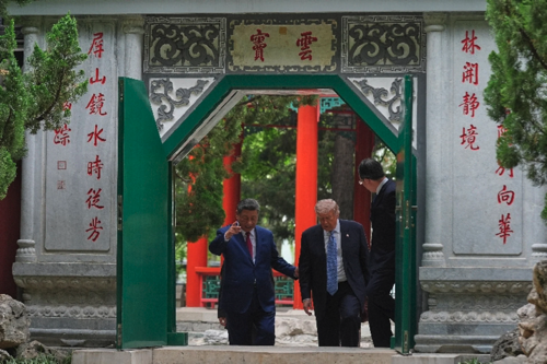 Trump walks with China’s President Xi Jinping at the Zhongnanhai leadership compound, Friday, May 15, 2026